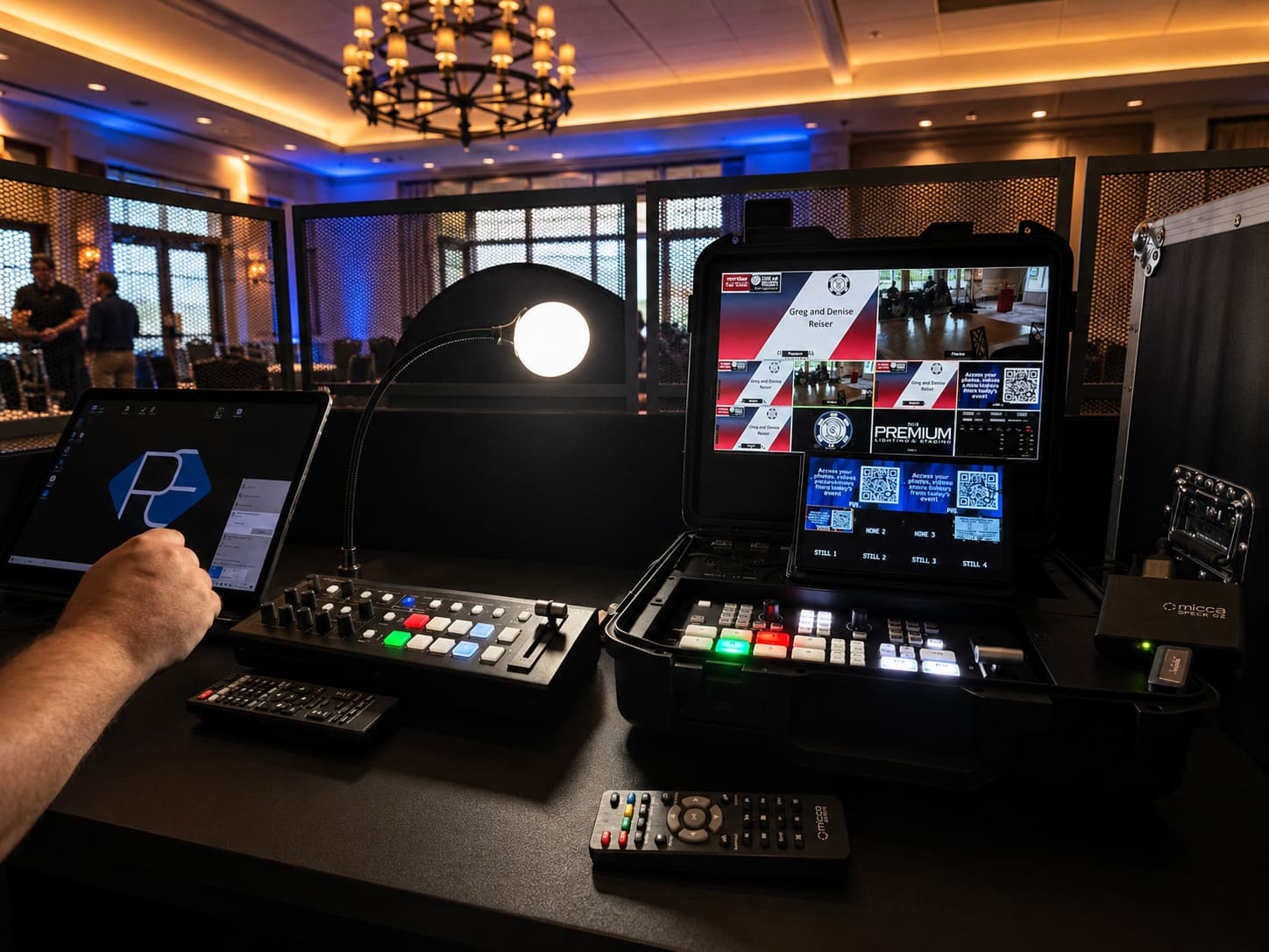 PremiumAVC MagicTag interactive touchscreen station in a Pelican case showing a photo-share event app with switcher hardware at a corporate gala